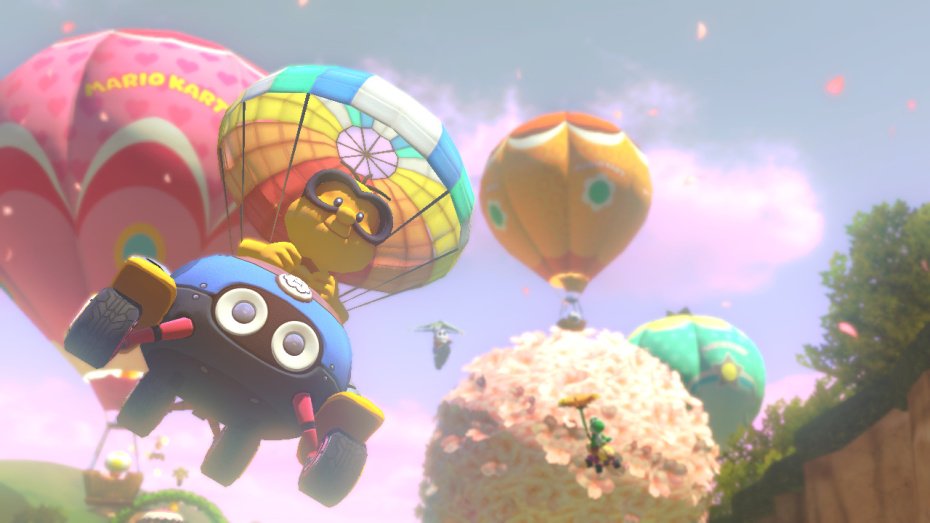 Mario Kart 8 kurvailee trailereilla ja sateenkaaritien kuvilla