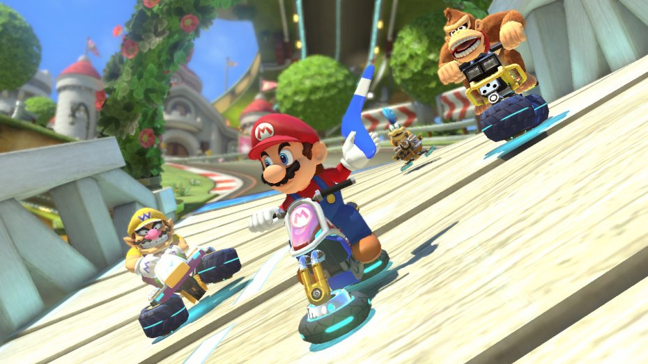 Mario Kart 8 kurvailee trailereilla ja sateenkaaritien kuvilla